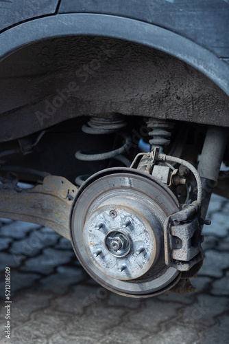 Brake disc and used brake pads on old car