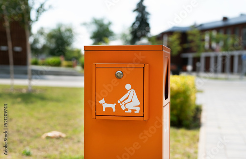 Pet waste station with dog poop bags and garbage in the park for pet owners.