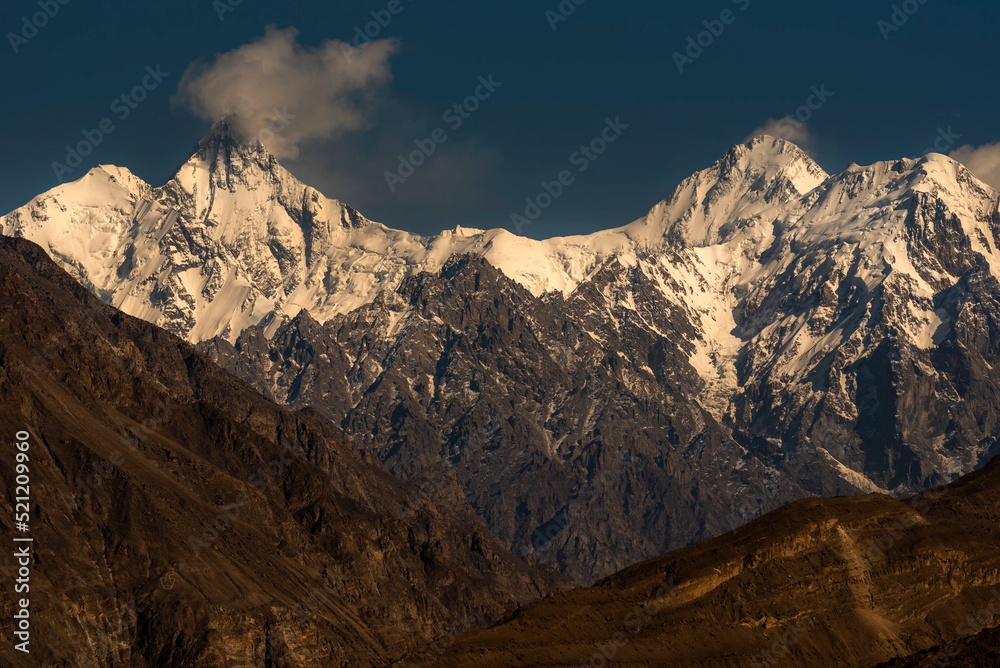 Landscape image of Snow mountains and blue sky in background 