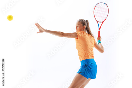 Portrait of sportive woman, professional tennis player serving ball isolated over white studio background