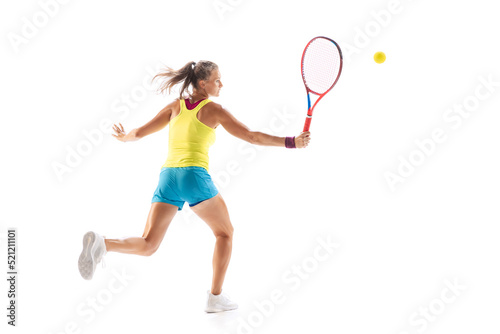 Portrait of young sportive woman, professional tennis player hitting ball with racket, training isolated over white studio background