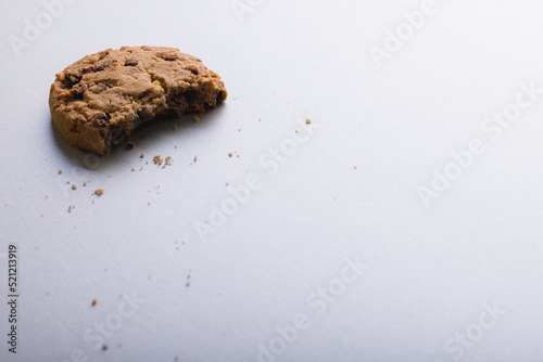 High angle view of half eaten cookie on white background with copy space