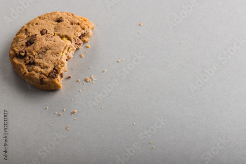 High angle view of half eaten cookie on gray background with copy space