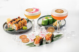 Set of different sushi rolls and cocktails on white background