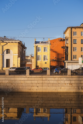 colored historical buildings on the embankment along the river in the city