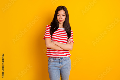 Photo of confident pretty young woman dressed striped outfit arms crossed isolated yellow color background