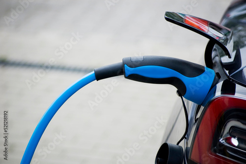 Recharging electric car by power cable.