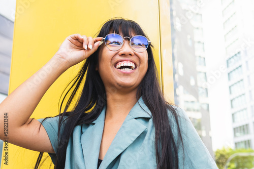 Stylish ethnic woman adjusting glasses