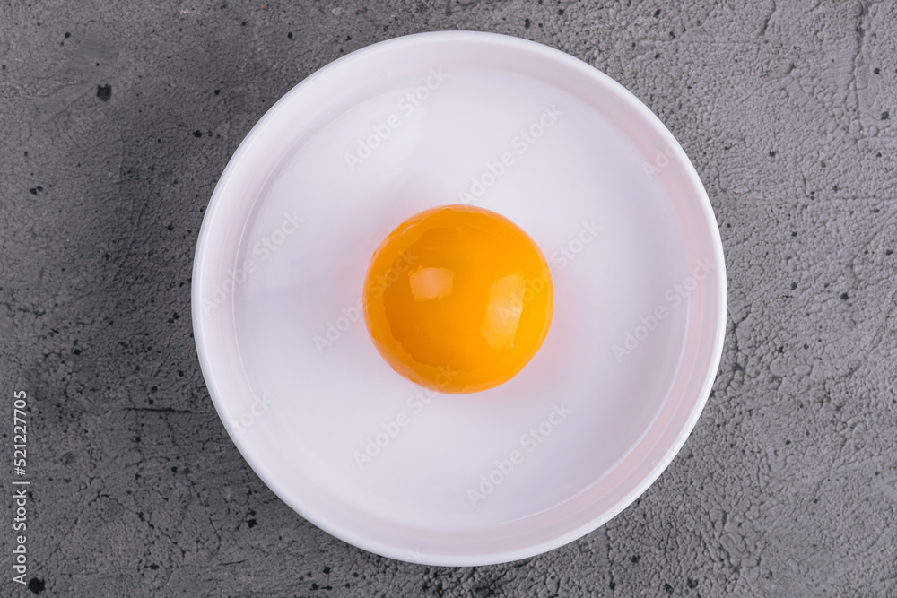 Egg yolk in bowl separated for cooking - obrazy, fototapety, plakaty 