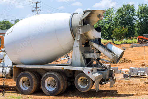 Delivery concrete mixer truck the fresh concrete for preparing to pour concrete into foundation in construction site