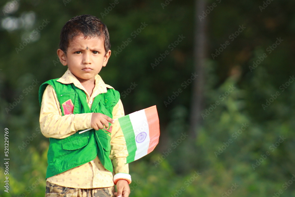 little indian boy proudly holding Tricolour Indian National flag. Stock