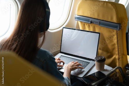 Beautiful asian travel woman using laptop computer in airplane