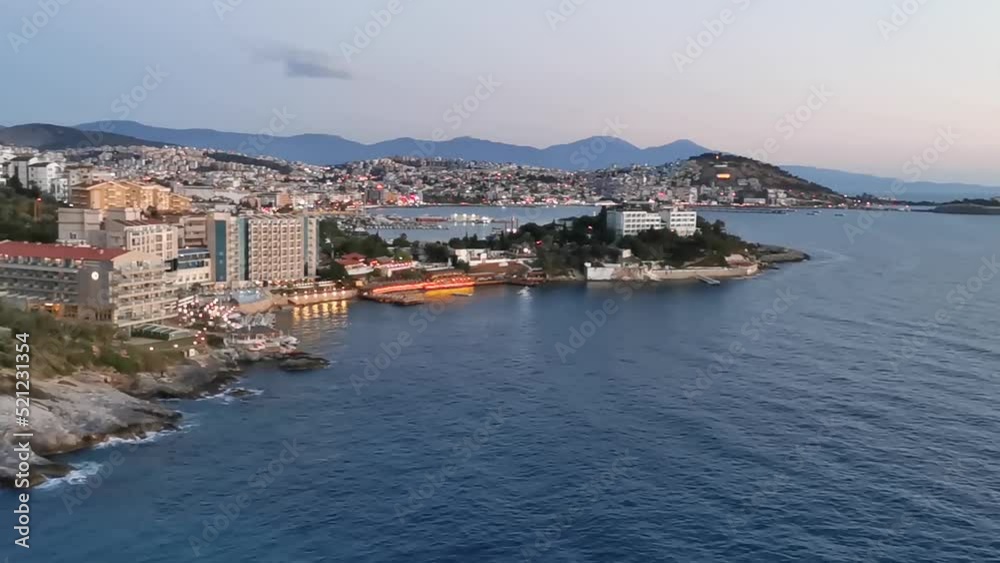 Beautiful evening view of the city and the Aegean Sea from the balcony. Turkey, Kusadasi. Panorama of the resort town at sunset. Beautiful evening view of the city and the Aegean Sea from the balcony. Turkey, Kusadasi. Panorama of the resort town at sunset.