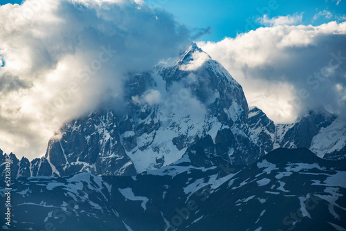 Beautiful snow covered mountains Ushba on the sunset, is one of the most notable peaks of the Caucasus Mountains. It is located in the Svaneti region of Georgia.