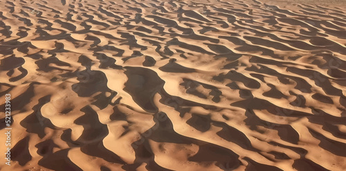 Beautiful design of sand dunes in the desert on a hot summer day