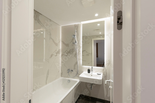 Interior of a bathroom with white marble walls