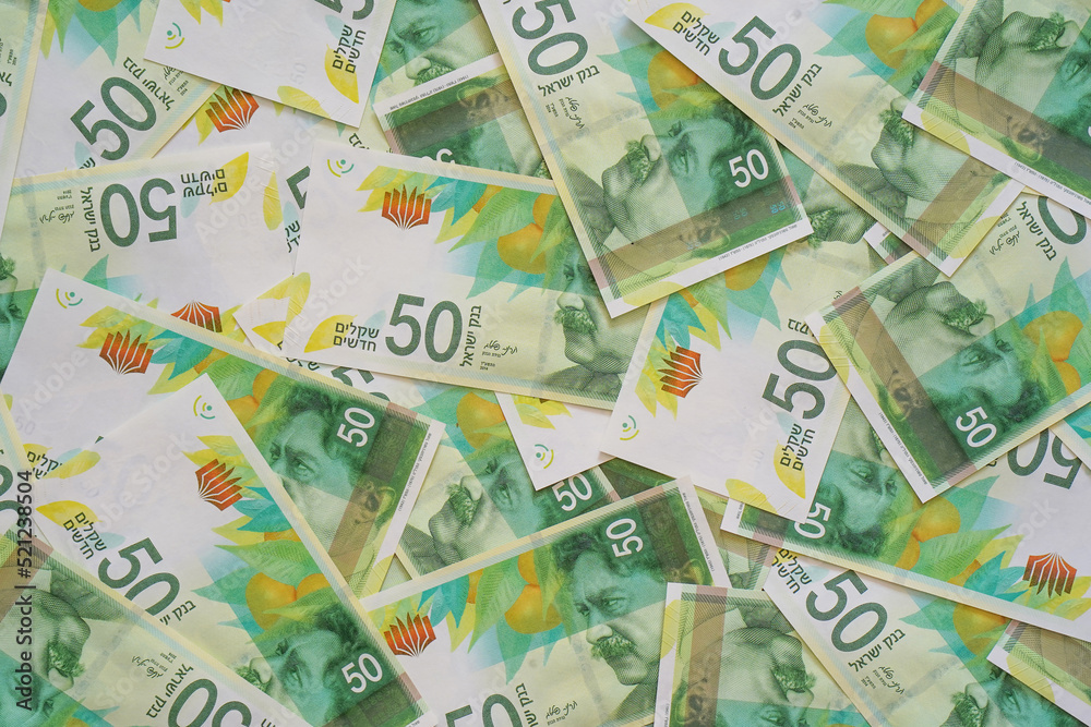 Fototapeta premium Israeli money stack of the new Israeli money bills (banknotes) of 50 shekel. New Israeli Shekel series C