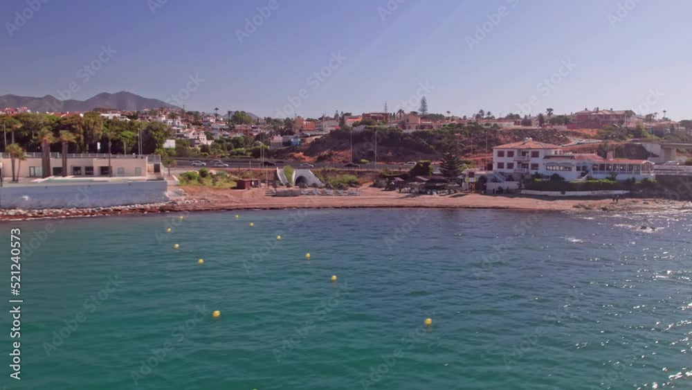 Aerial shot of the coastline in Mijas Costa with resorts and road traffic