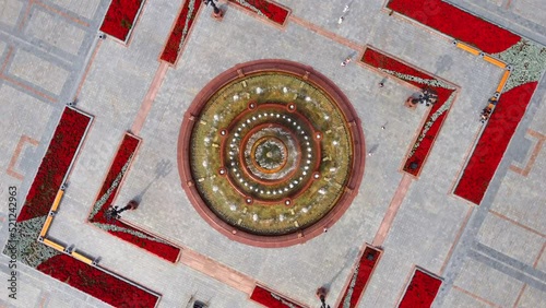A round fountain in the center of the city square. A local landmark in Khabarovsk on Lenin Square. The Far Eastern region of Russia.  Shooting from above by drone. 