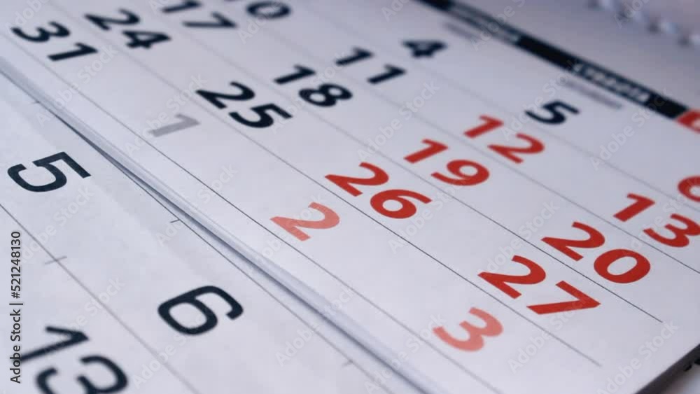 A man flip through the calendar, close up. Months passing, reminding year plans and holidays dates A man flip through the calendar, close up. Months passing, reminding year plans and holidays dates