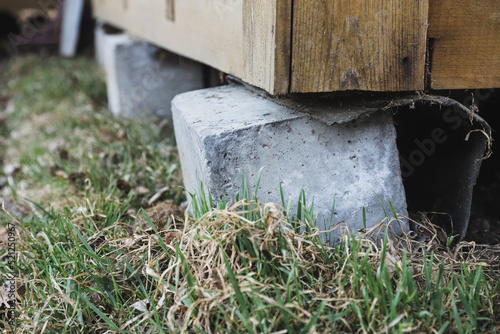 Rickety concrete support of a country house close-up. Selective focus