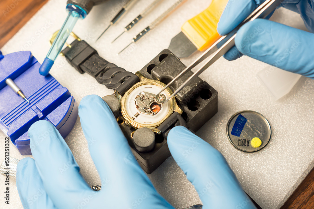 Watchmaker replacing battery in quartz watch, Watch maintenance service.