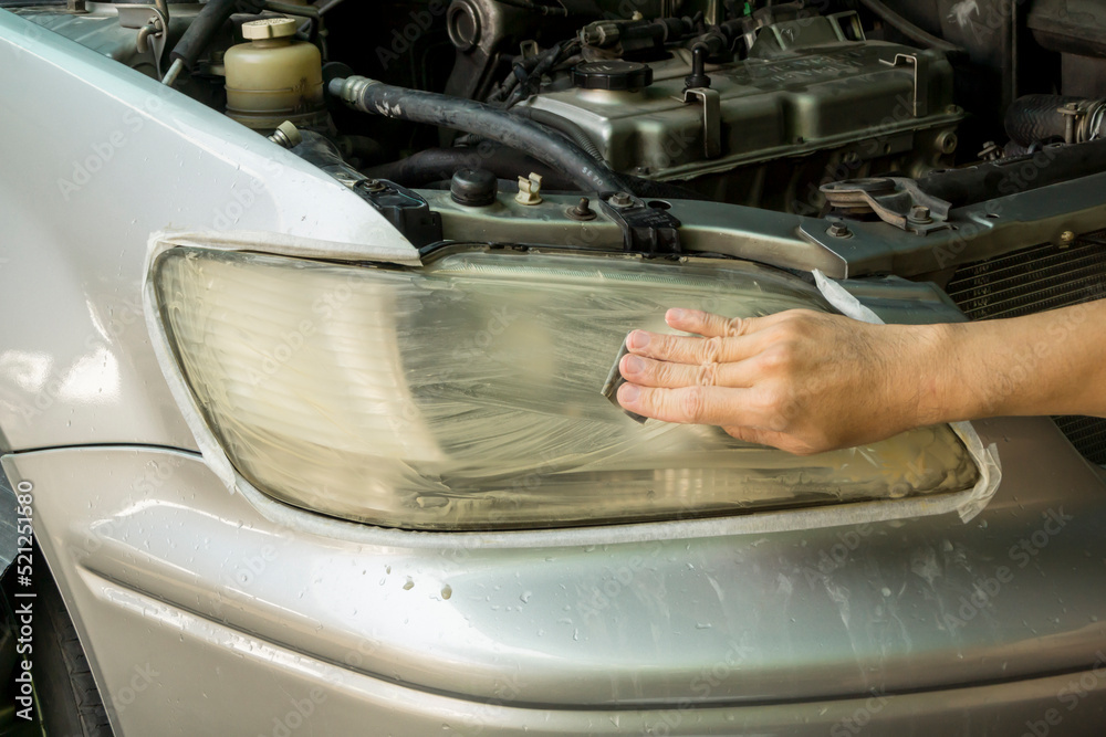 Headlight Lens Polish with sandpaper, Car maintenance service.