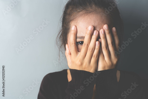 Phobia, the girl hides her face with her hands and peeks into the gap between her fingers. specific phobia, agoraphobia.  photo