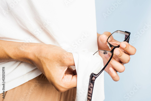Wallpaper Mural Close-up of a woman's hand wipes her glasses with a shirt. Torontodigital.ca