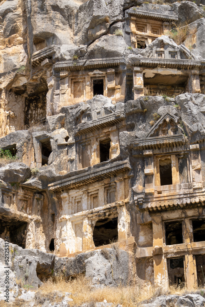 View of the Lycian tombs in the ancient city of Myra, climbed on the mountain on a sunny day.