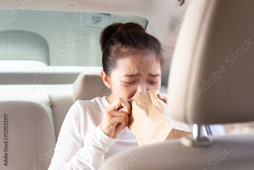 Wallpaper Mural Asian woman experiencing motion sickness and vomiting during travel, vomit bags, nausea, travel sickness Torontodigital.ca