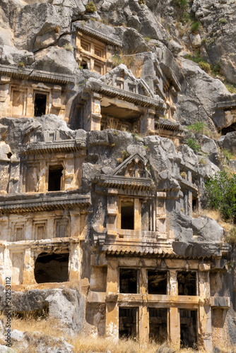 View of the Lycian tombs in the ancient city of Myra, climbed on the mountain on a sunny day.