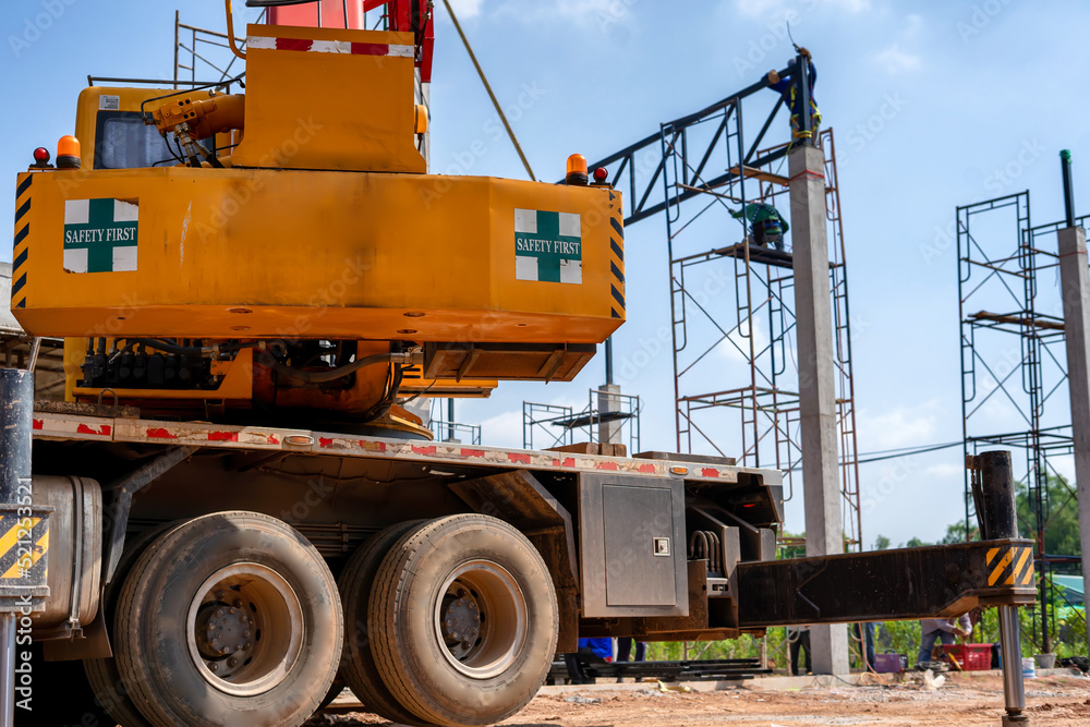 Cranes lift roof structures in industrial construction sites. Cranes lift roof structures in industrial construction sites.