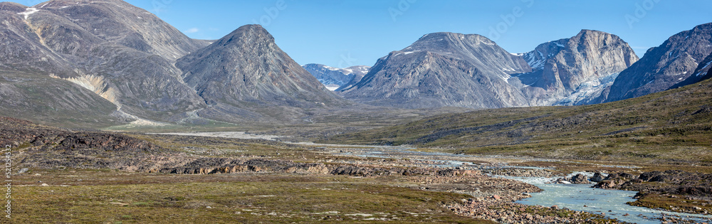 Panoramic landscape of mountains and meltwater river at Camp Frieda on the Disko Bay coast, Greenland on 18 July 2022
