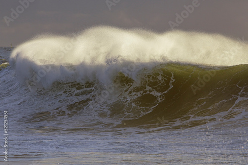 Photography Backlit stormy wave spray at sunset
