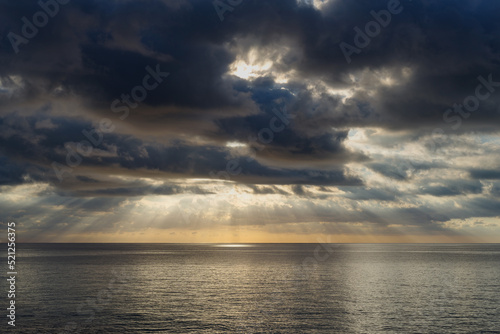 Dark cumulus clouds hovering over the sea