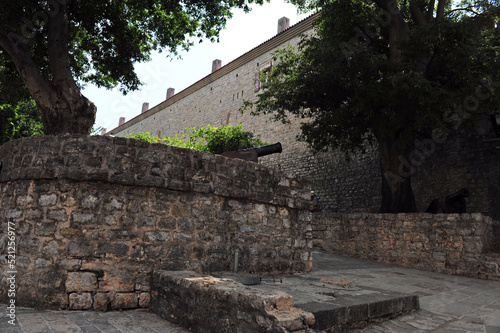 Entrance to the fortress Citadela in Budva, Montenegro.  Brick walls with canon. Horizontal photo.