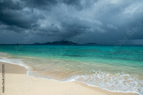 Картината върху платно Jost Van Dyke surrounded by tropical squall clouds viewed across turquoise Carib