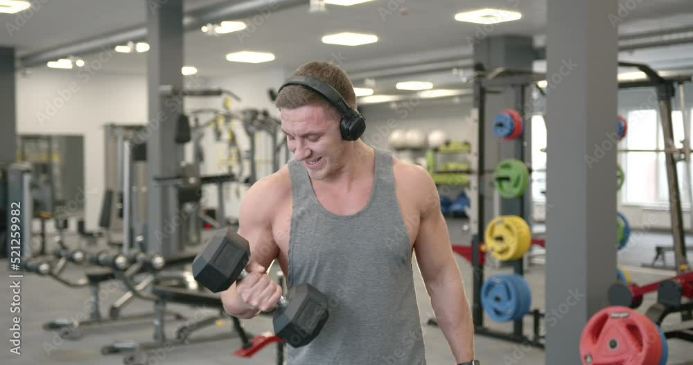 Sporty man exercise with dumbbells at gym Sporty man exercise with dumbbells at gym