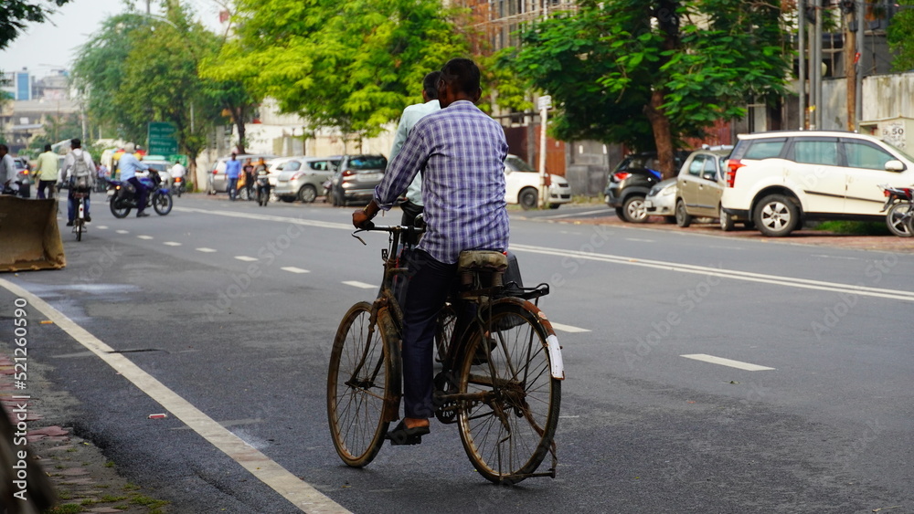 image of indian man going on bicycle.