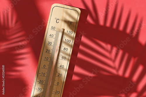 Wooden thermometer showing 40 degrees Celsius or 104 degrees Fahrenheit during summer heat wave photo