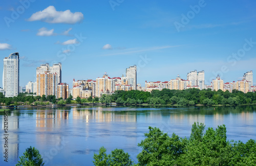  View at residential district Obolon on the bank of Dnieper river at sunny summer day. Kyiv, Ukraine.