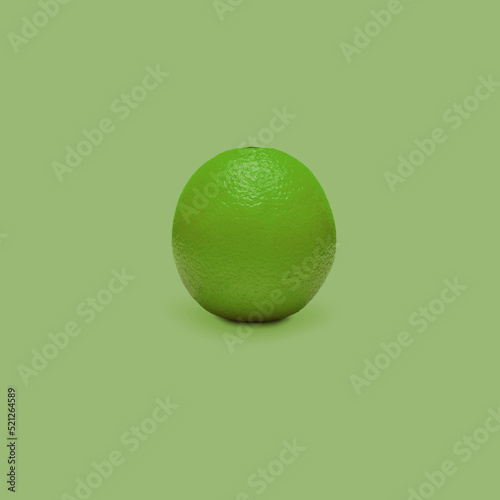 Green orange fruit isolated on green background. The concept of the benefits of citrus fruits.