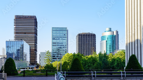 Modern steel and glass buildings lined up on the horizon in the financial district of the city of Madrid, Spain.