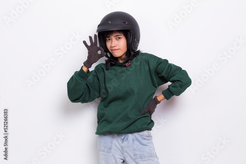 beautiful asian woman with a motorcycle helmet showing a thumbs up ok gesture on white background 