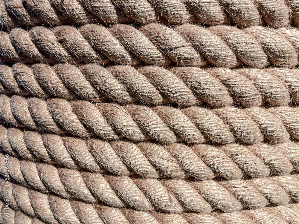 texture, background. a strong, solid rope is wound on a reel. twine for binding made of durable brown material. threads are pulled from the rope texture, background. a strong, solid rope is wound on a reel. twine for binding made of durable brown material. threads are pulled from the rope
