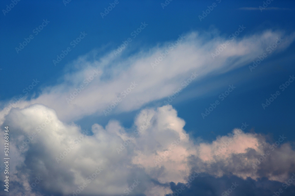 white fluffy clouds on blue sky. Weather concept