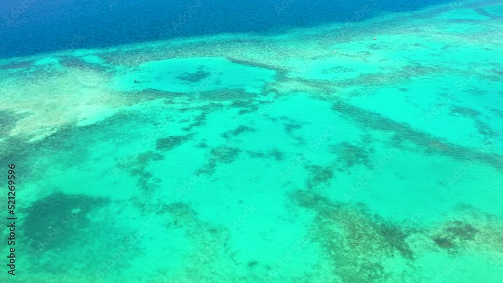 Transparent turquoise sea water, natural background. Overhead view of rippled sea blue water. Transparent turquoise sea water, natural background. Overhead view of rippled sea blue water.