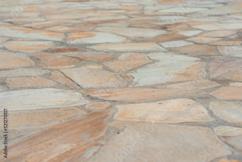 Garden path made of yellow sandstone stones close-up