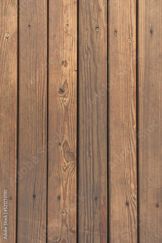 Brown wooden slats, worn texture, vertical photo